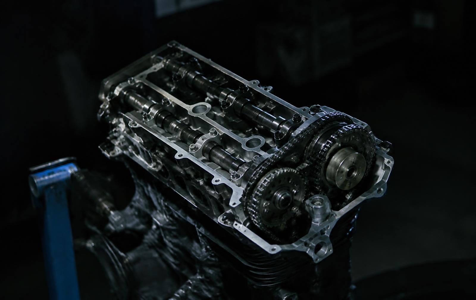 Motorcycle cylinder head on a workshop stand (illustrative image)